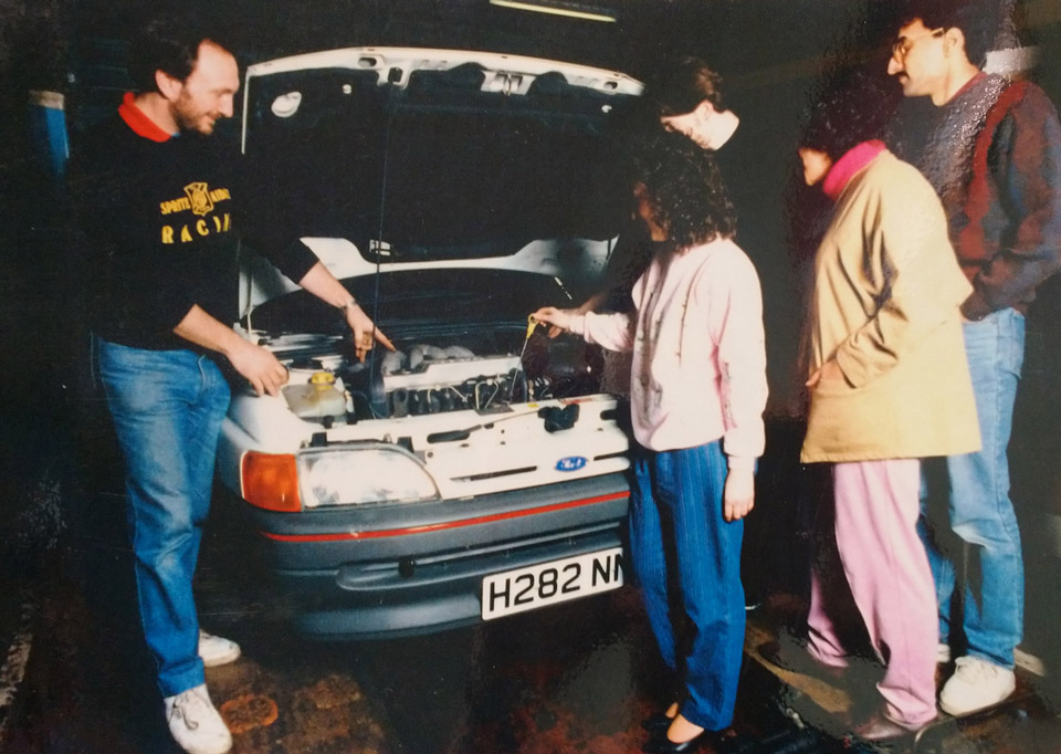 Photo from the 1990s of learners in a car mechanic class