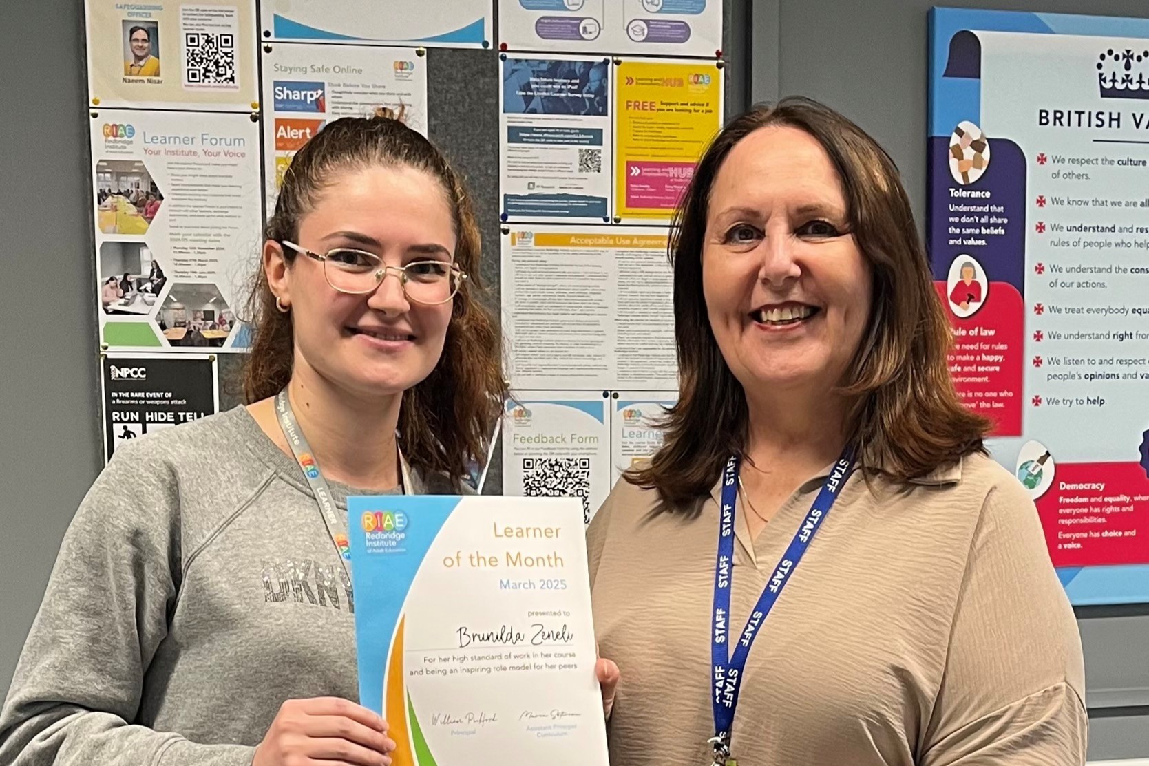 Learner with her tutor receiving a certificate