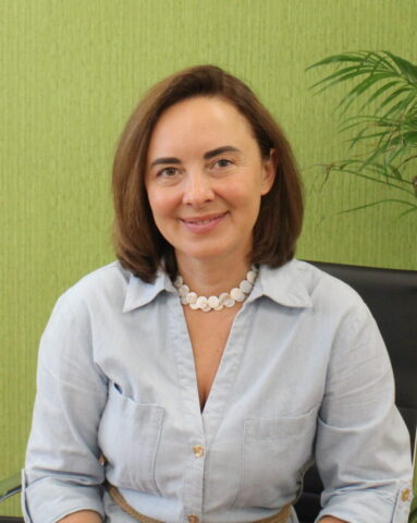 Woman sitting in front of a green background